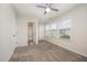 Bedroom featuring carpet, bright windows with blinds, and ensuite bathroom at 6107 Kayton St, Raleigh, NC 27616