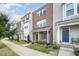 Inviting exterior view of townhomes, showcasing their brick facade and well-manicured lawns on a bright day at 6107 Kayton St, Raleigh, NC 27616