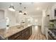 Open-concept kitchen with granite countertops, stainless steel appliances, and views of the living area at 6107 Kayton St, Raleigh, NC 27616