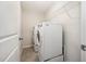 Laundry room with full sized washer and dryer, and metal shelving at 6107 Kayton St, Raleigh, NC 27616