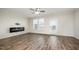 Spacious living room with hardwood floors, a modern fireplace, and plenty of natural light at 6107 Kayton St, Raleigh, NC 27616