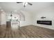 Open concept living room flows from kitchen, offering a fireplace, ceiling fan, and luxury vinyl flooring at 6107 Kayton St, Raleigh, NC 27616