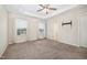 Bright main bedroom with tray ceilings, plush carpet, two windows, and a TV mount for entertainment at 6107 Kayton St, Raleigh, NC 27616