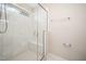 Contemporary shower featuring white tile walls, glass door, and a built-in bench for relaxation at 6107 Kayton St, Raleigh, NC 27616
