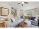 Cozy living room with a large sectional sofa, ceiling fan, and bright natural light at 6301 Pesta Ct, Raleigh, NC 27612