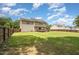 Expansive backyard view from the side shows a wooden fence, lush lawn, and a home exterior at 642 Pinevalley Ln, Sanford, NC 27332