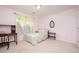 Bright bedroom with a decorative window and a bed, complemented by a small desk and a bedside table at 642 Pinevalley Ln, Sanford, NC 27332