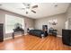 A bedroom with a fan, dark furniture, hardwood floors and neutral walls at 642 Pinevalley Ln, Sanford, NC 27332