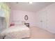 Bedroom with a bed, side table, and a window, and featuring a closet with double doors at 642 Pinevalley Ln, Sanford, NC 27332