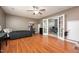 A bedroom with hardwood floors, and doors leading to an office space at 642 Pinevalley Ln, Sanford, NC 27332