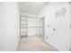 Walk-in closet with neutral carpeting, built-in shelving on the left, and a full-length mirror on the wall at 642 Pinevalley Ln, Sanford, NC 27332