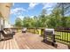Outdoor wooden deck features patio furniture and a grill, perfect for entertaining guests at 642 Pinevalley Ln, Sanford, NC 27332