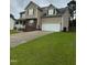 Attractive two-story home featuring neutral siding, a spacious driveway, and an attached two-car garage at 642 Pinevalley Ln, Sanford, NC 27332