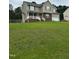 Charming two-story home with neutral siding, green shutters, and a well maintained lawn at 642 Pinevalley Ln, Sanford, NC 27332