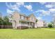 Side view of a cozy two-story home with a porch, lush lawn, and tree lined streets at 642 Pinevalley Ln, Sanford, NC 27332
