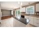 Bright kitchen features white cabinets, a black countertop island, and stainless steel appliances at 642 Pinevalley Ln, Sanford, NC 27332