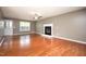 Bright, open living room with a fireplace, hardwood floors, and natural light streaming through windows at 642 Pinevalley Ln, Sanford, NC 27332