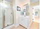 Bright bathroom featuring a glass-enclosed shower, a modern vanity, and updated fixtures at 65 Shorrey Pl, Youngsville, NC 27596