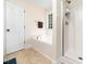 Bright bathroom featuring a separate tub and shower at 65 Shorrey Pl, Youngsville, NC 27596