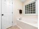 Bright bathroom featuring a separate tub at 65 Shorrey Pl, Youngsville, NC 27596