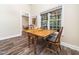 Inviting dining area with hardwood floors and a large window view to the outdoors at 65 Shorrey Pl, Youngsville, NC 27596