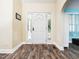 Welcoming foyer featuring updated floors and decorative trim around a white front door at 65 Shorrey Pl, Youngsville, NC 27596
