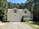 Traditional home with a 2-car garage, dormer windows, and a manicured lawn at 65 Shorrey Pl, Youngsville, NC 27596