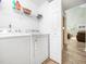 Bright laundry room features a Whirlpool washer and dryer and wire shelving for storage at 65 Shorrey Pl, Youngsville, NC 27596