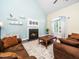 Cozy living room with fireplace, vaulted ceilings, and comfortable brown sofas at 65 Shorrey Pl, Youngsville, NC 27596