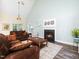 Relaxing living room featuring a black fireplace, comfortable sofas, and decorative accents at 65 Shorrey Pl, Youngsville, NC 27596
