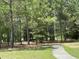 A peaceful walking path winds through a serene wooded area with mature trees at 65 Shorrey Pl, Youngsville, NC 27596