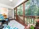 Relaxing screened porch with outdoor seating, ceiling fan, and sliding door leading to the dining room at 65 Shorrey Pl, Youngsville, NC 27596