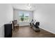 Bright bedroom with a ceiling fan and exercise equipment at 7117 Crested Iris Pl, Durham, NC 27703