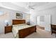 Comfortable bedroom features ample natural light, a ceiling fan, and wood furniture at 7117 Crested Iris Pl, Durham, NC 27703