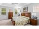 Spacious bedroom boasts natural light, complemented by stylish furnishings and a ceiling fan at 7117 Crested Iris Pl, Durham, NC 27703