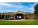 Brick clubhouse with fenced-in pool and ample green space for community gatherings at 7117 Crested Iris Pl, Durham, NC 27703