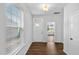 Bright and inviting foyer with wood flooring, a front door, and a view into another room at 7117 Crested Iris Pl, Durham, NC 27703