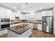 Spacious kitchen with white cabinets, stainless steel appliances, and dark countertops at 7117 Crested Iris Pl, Durham, NC 27703