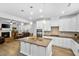 Open concept kitchen with large island flows into cozy living room with fireplace at 7117 Crested Iris Pl, Durham, NC 27703