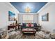 Stylish living room features a unique blue ceiling, comfortable seating, and tasteful decor at 7117 Crested Iris Pl, Durham, NC 27703