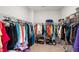 Spacious walk-in closet with ample storage, shelves, and hanging racks for organization at 7117 Crested Iris Pl, Durham, NC 27703