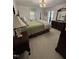 Cozy bedroom features matching furniture with a nice lamp and bright windows at 7140 N Ridge Dr, Raleigh, NC 27615