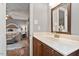 Bathroom vanity with solid surface countertops and a view of the bedroom at 7209 St Ledger Dr, Raleigh, NC 27613