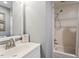 A bathroom with a single sink vanity next to a tub/shower at 7209 St Ledger Dr, Raleigh, NC 27613