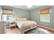 A bedroom with hardwood floors, neutral paint, and natural lighting at 7209 St Ledger Dr, Raleigh, NC 27613