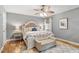 A charming bedroom with hardwood floors, a ceiling fan, neutral paint, and a bed with decorative headboard at 7209 St Ledger Dr, Raleigh, NC 27613