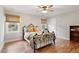 Bedroom featuring a wrought iron bed frame, hardwood floors, and neutral walls at 7209 St Ledger Dr, Raleigh, NC 27613