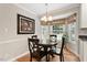 Charming dining area with a round table, four chairs, hardwood floors, and a large bay window at 7209 St Ledger Dr, Raleigh, NC 27613