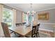 Elegant dining room with hardwood floors, crown molding, and soft gray walls with an elegant chandelier at 7209 St Ledger Dr, Raleigh, NC 27613
