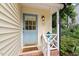 Charming front door with blue paint, decorative details, and a welcoming porch at 7209 St Ledger Dr, Raleigh, NC 27613